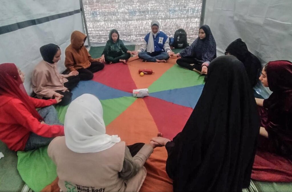 Adolescence do a meditation exercise in Gaza