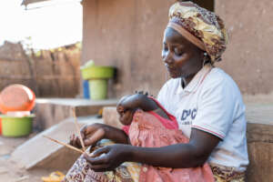Radio listeners, mother and child, Mozambique