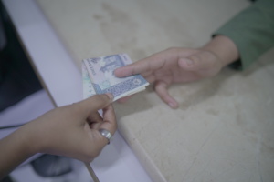 A mother giving money for her child's treatment