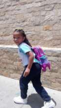 Salome is happy to go to school with her backpack