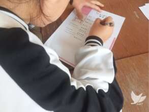 A Lao girl filles in an application form for study