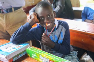 Elijah Happy After Receiving the Educational Items