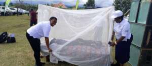 Demonstration of how to use mosquito nets.