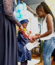 Peter receiving a bouquet from his mother.