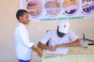 "Dr. Hamze performing an eye examination a student