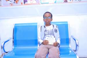 A young boy receives eyeglasses