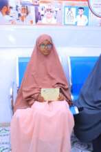 A young girl receives eyeglasses