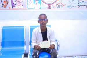 A young boy receives eyeglasses