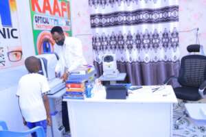 "Dr. Hamze performing an eye examination a student