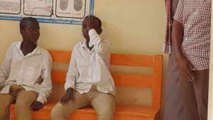 Brothers undergoing eye screenings at school.