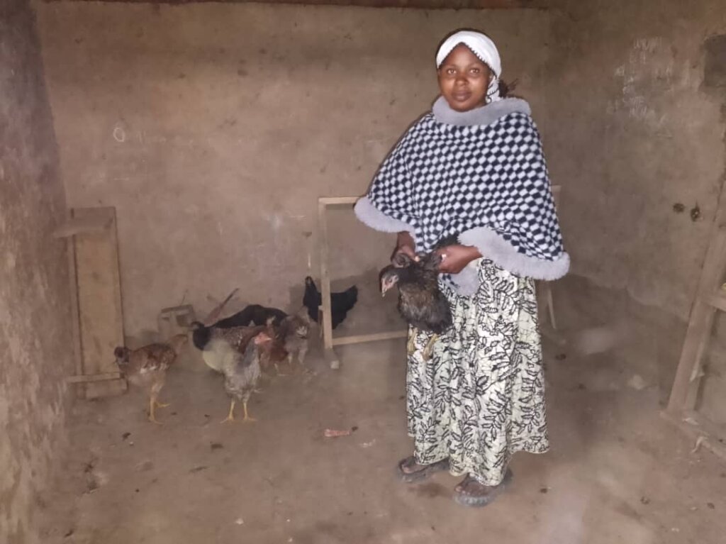 Zawadi showing her 7 chicken including 2 from YICE