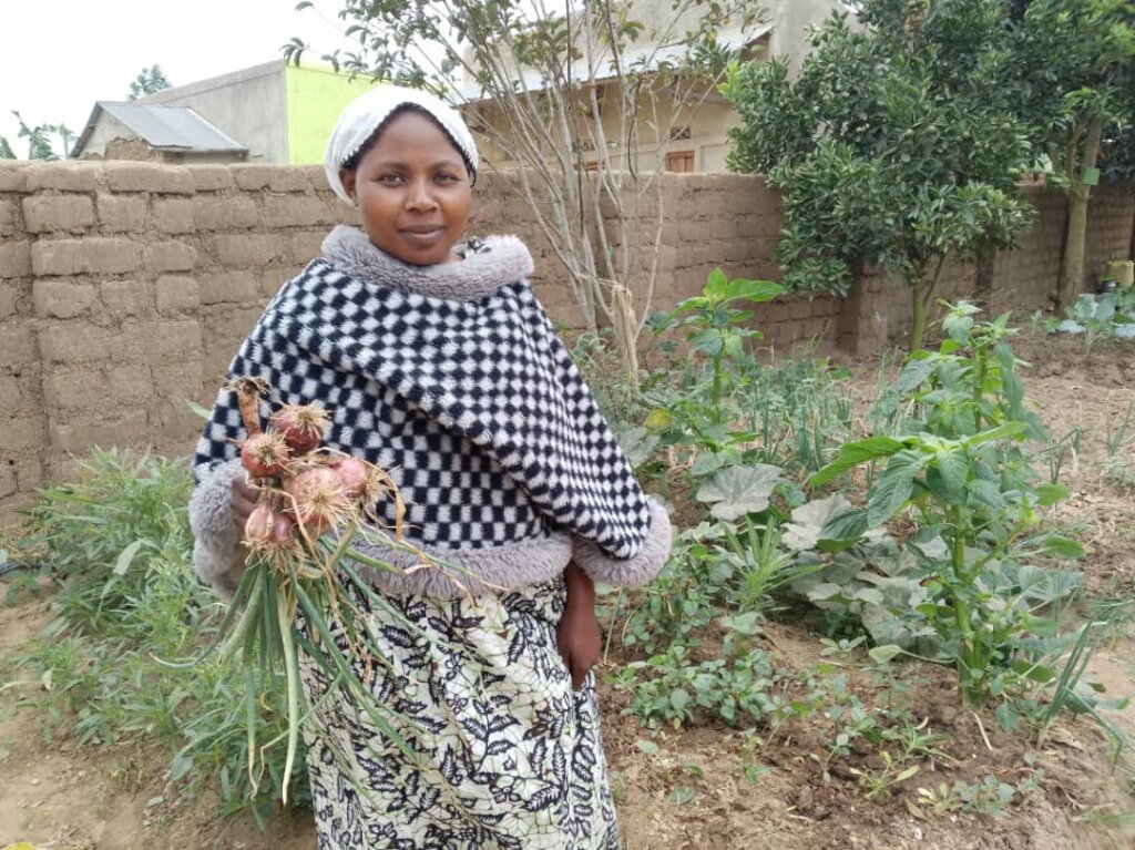 Zawadi showing her onion harvest