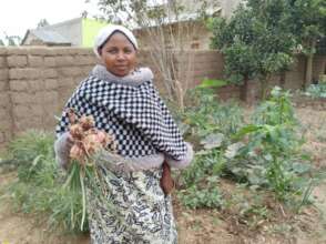 Zawadi showing her onion harvest