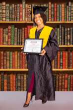 Germanie Proudly Holding Her Diploma