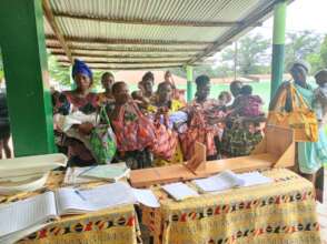 The women at the clinic receiving the baby bags.