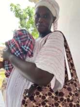 Binta with her new baby and her baby bag.