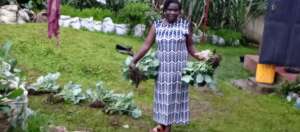 JANE TAKING HER VEGETABLES FOR PLANTING.jpg