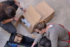 Volunteers unpack the carder after its trip down!