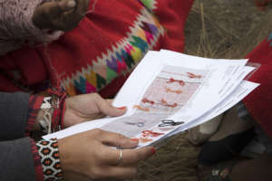 Ale helps to explain her designs to the weavers.