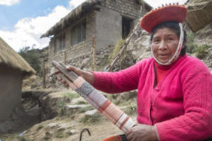 Justina shows off her weaving on the loom.