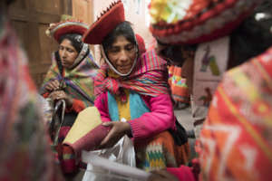 Toribia reviews the next textile samples.