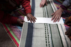 A design intern helps Isadora with the cartulina.
