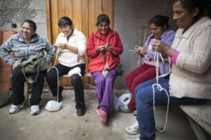 Rosa, Matilda, Demi, Yudi, & Isabel knit together.