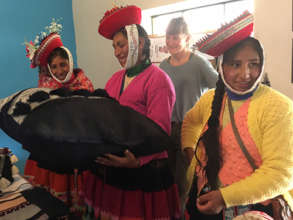 Weavers from Patacancha view the finished products