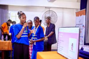Girls presenting the Mom HealthCare+ app.