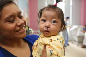 Mother with child post-surgery