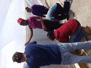 Teens helping construct the new compost hoop house