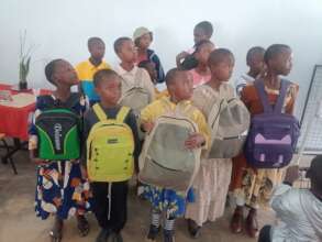 Children getting backpacks for school