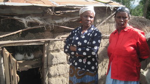 Women from group with rabbits in hutch
