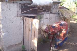 A group member cleaning the rabbit hutch