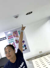 Head Midwife Marlene pointing to fire sprinklers