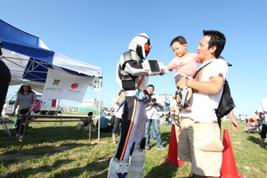 A handshake at an event in Soma City - AAR Japan