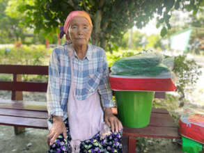 Woman receiving household items - Myanmar relief