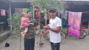 Guardian and children receive a tree