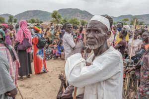 Man waits for a food card at displacement camp