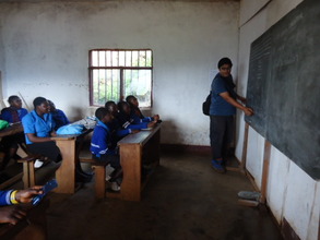 A Volunteer teaching the OVCs in Class