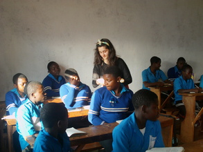 OUr voluteer teaching the orphaned children