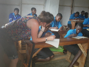 Tania our Volunteer teaching the OVCs English