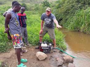 Working on the water pump with our staff