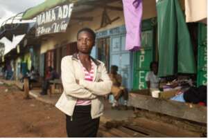Alumni Sarah in front of her shop