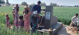 Young girls taking turns to collect water