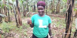 A farmer shows off her Portuguese cabbage seedling