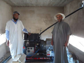 Community members and irrigation machinery