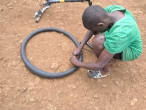 One of our boys repairs a bicycle puncture