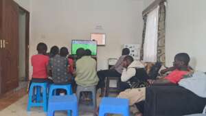 Boys watching live football (soccer) match on TV
