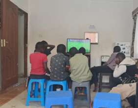 Boys watching a game of football on TV